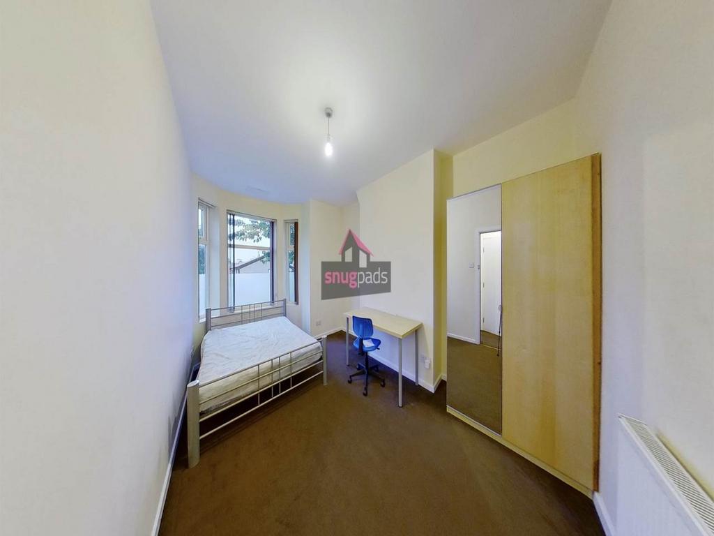 Neat single bedroom with a window at the far en...