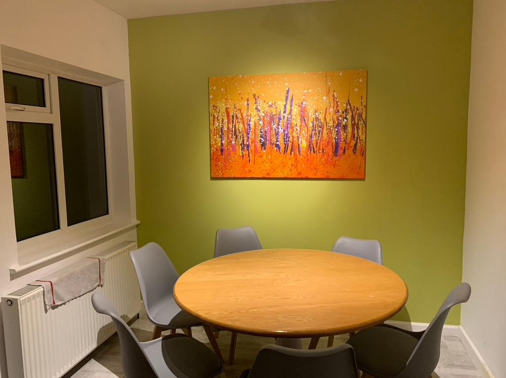 Bright, modern dining area with a round wooden ...