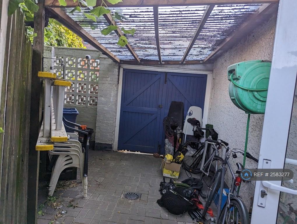Lean To At Side Of House With Bike Locked Storge