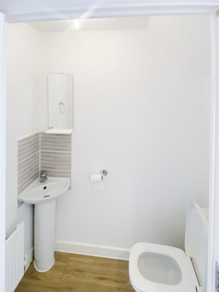 Bright, freshly painted WC with modern pedestal...