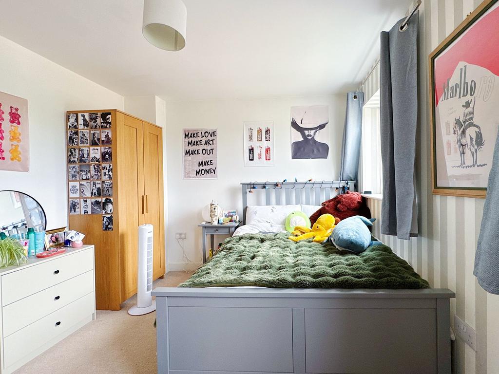 Bright, neatly styled double bedroom with a pai...