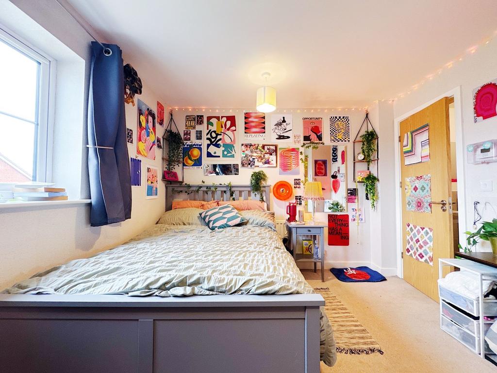 Bright and welcoming bedroom with a large bed, ...