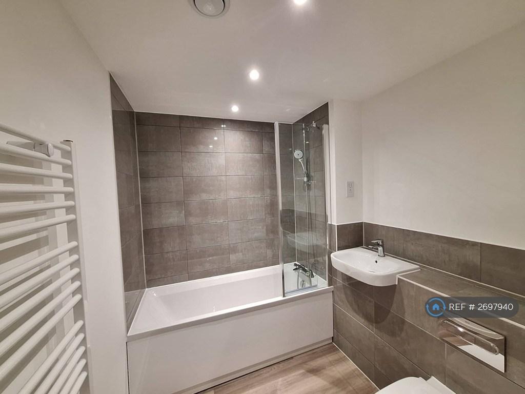 Bathroom With Tub And Shower With Folded Screen