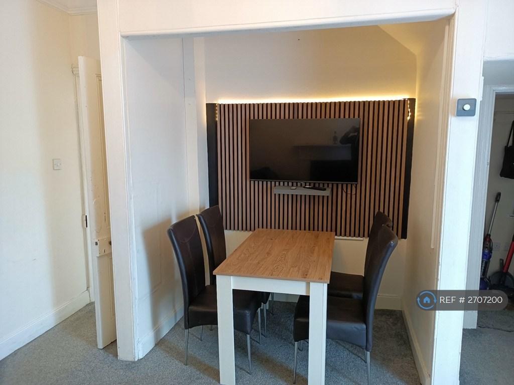 Tv Wall And Dining Area With Large Tv
