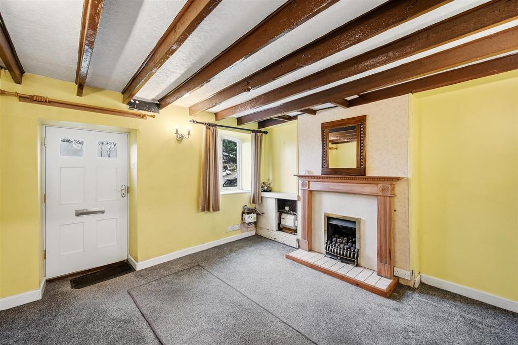 Sitting Room to fireplace and window.jpg