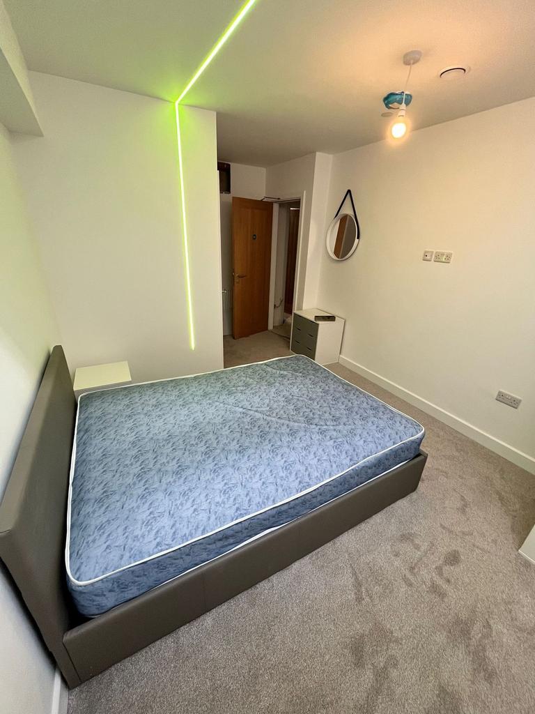 Bright, modern bedroom with a upholstered doubl...