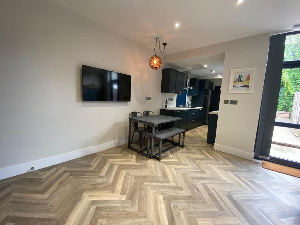 Bright open-plan living area with stylish herri...