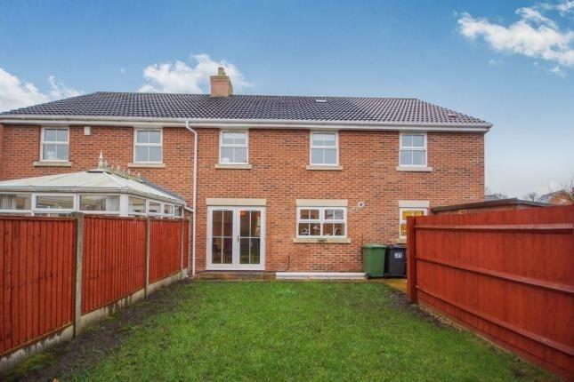 Well-kept rear garden with a lawn leading to a ...