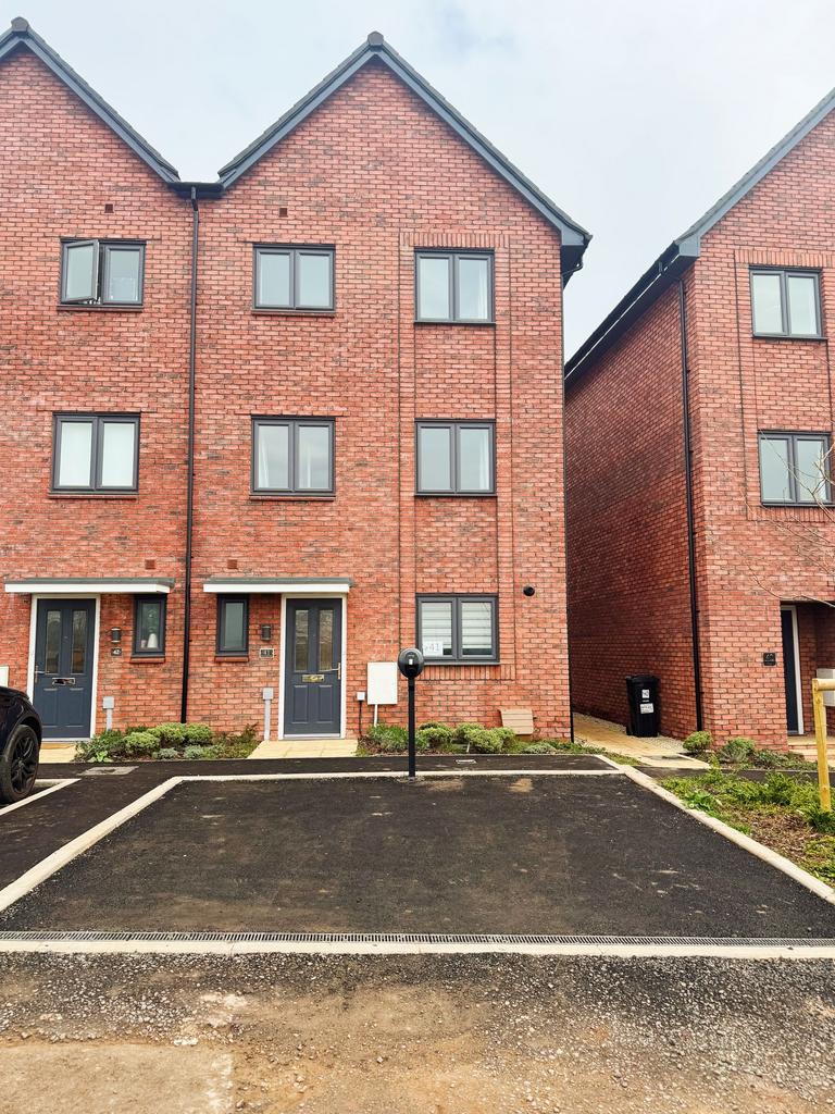 Modern redbrick townhouse with neat planting be...
