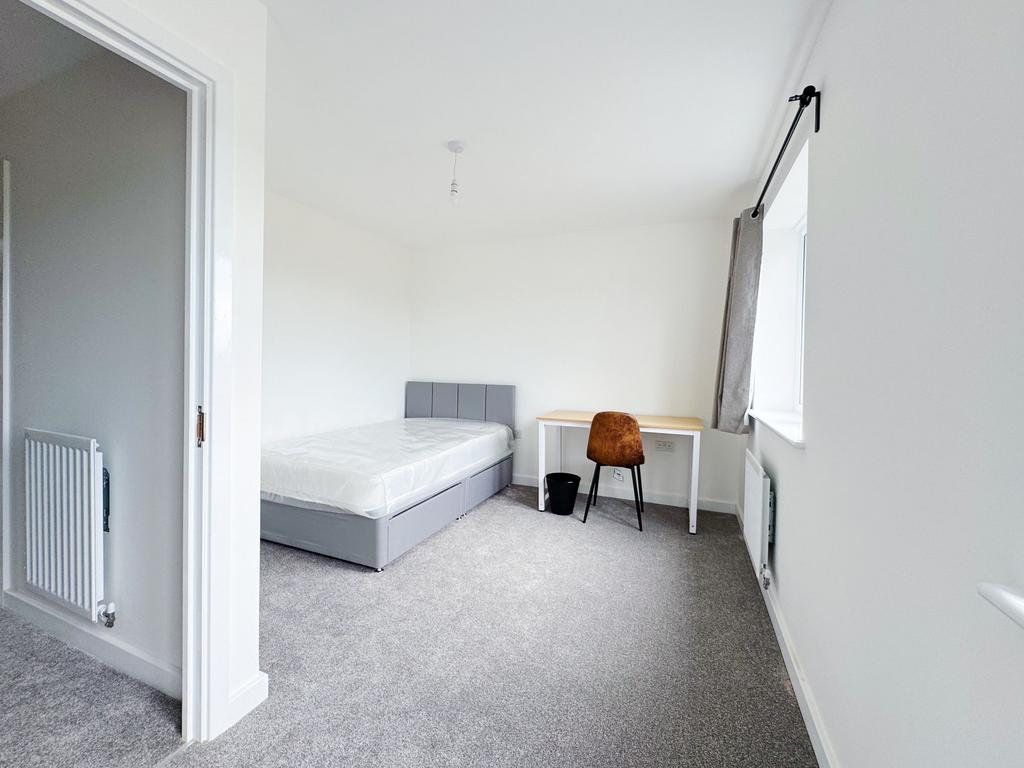 Bright, freshly redecorated bedroom with neutra...
