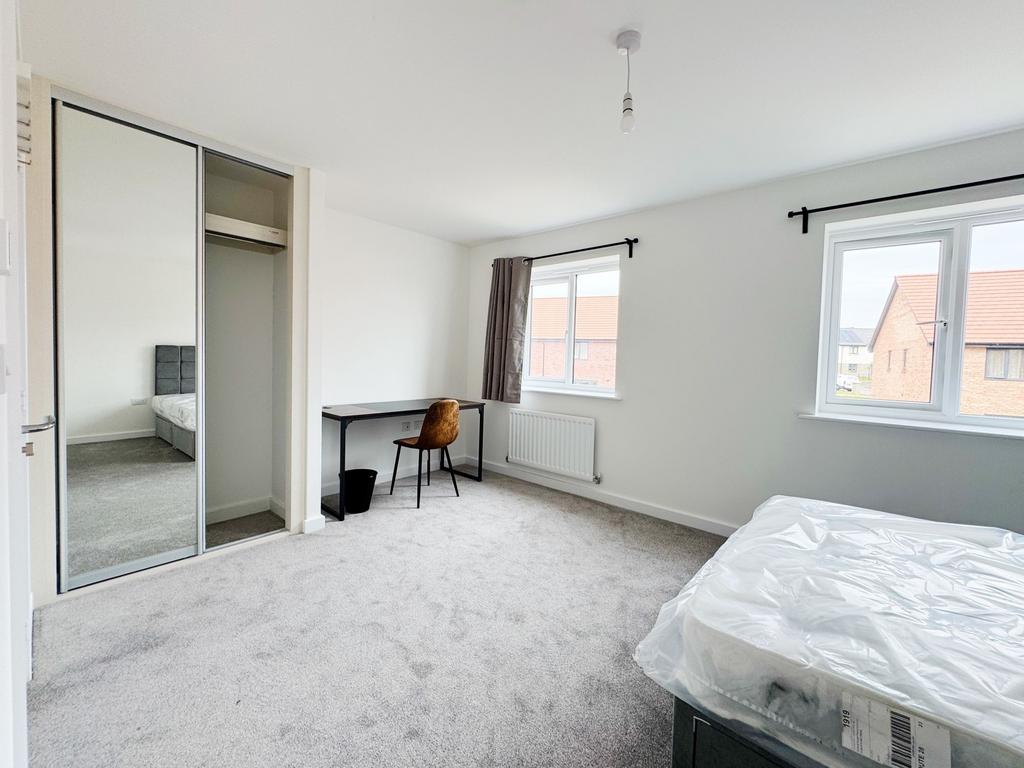 Bright, freshly carpeted master bedroom with tw...