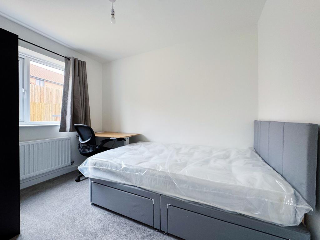 Bright, neatly presented bedroom with a comfort...