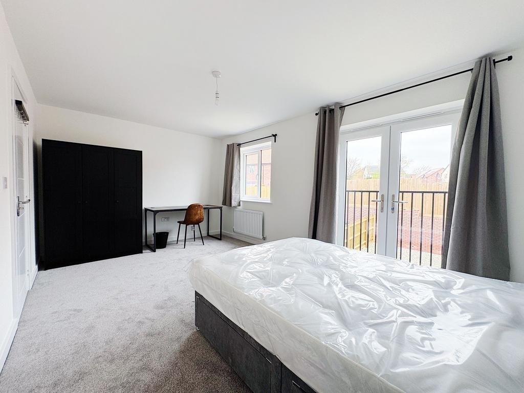 Bright, spacious bedroom with large french door...