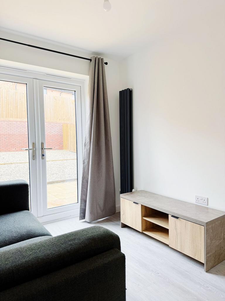 Bright, modern living area with large glass doo...