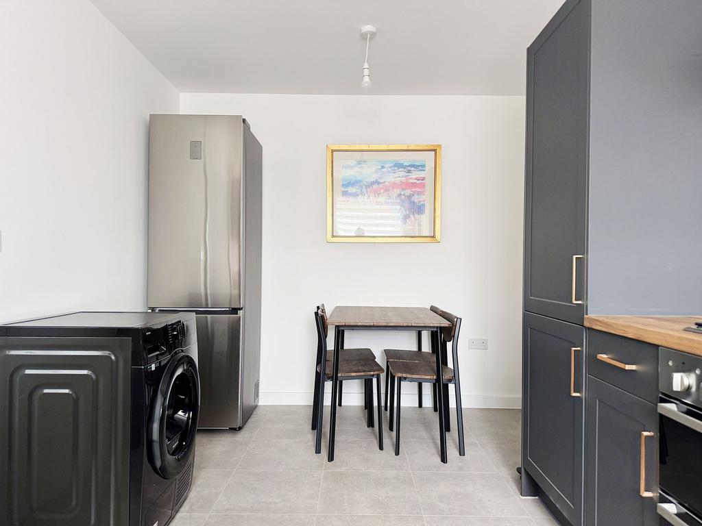 Bright, modern kitchen with sleek dark cabinetr...