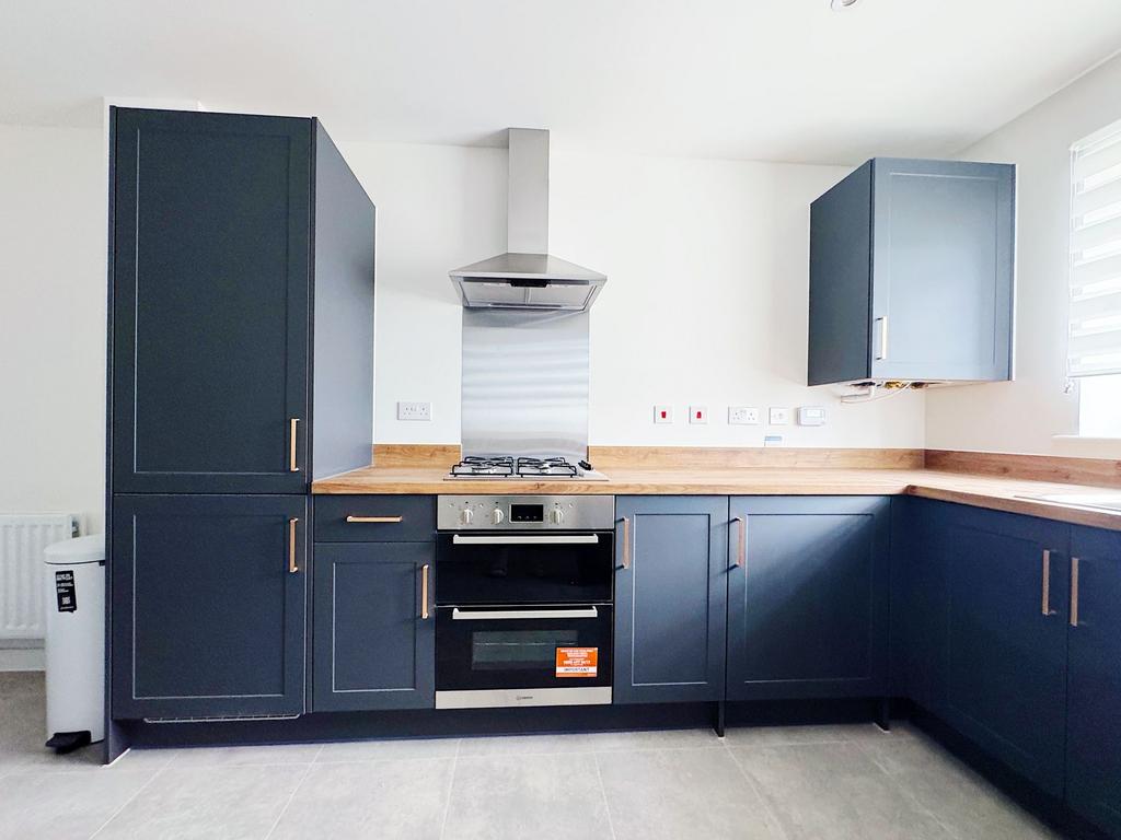 Modern fitted kitchen with navy shaker cabinets...