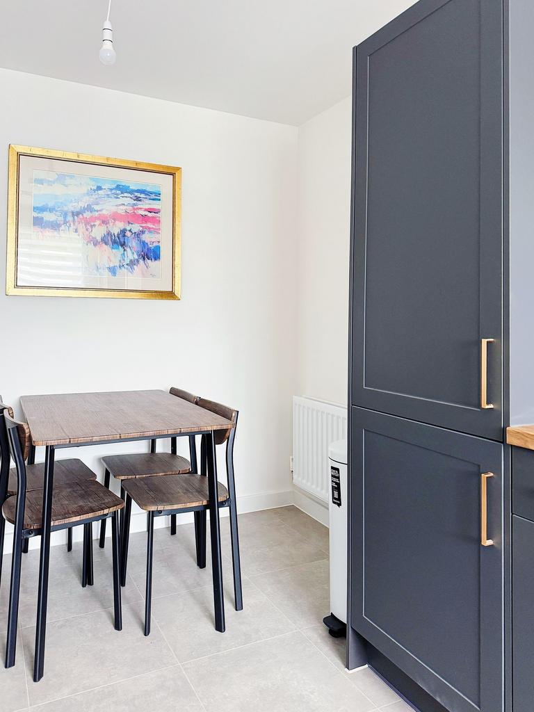 Bright modern kitchen dining nook with a compac...