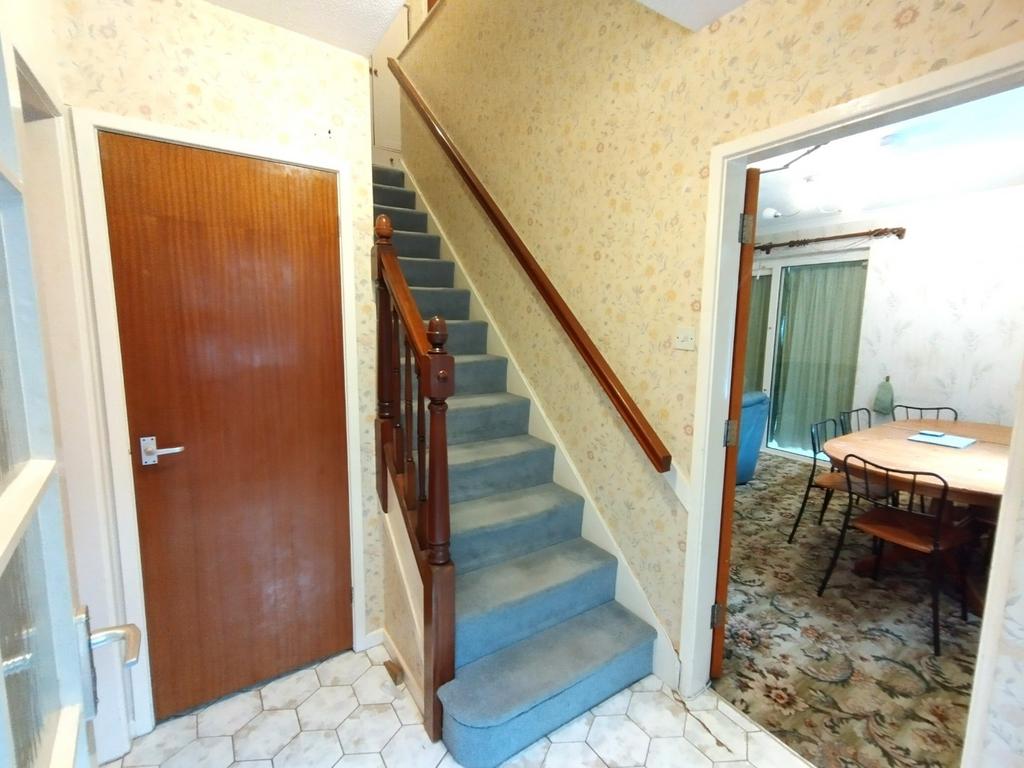 Welcoming entrance hallway with carpeted stairc...