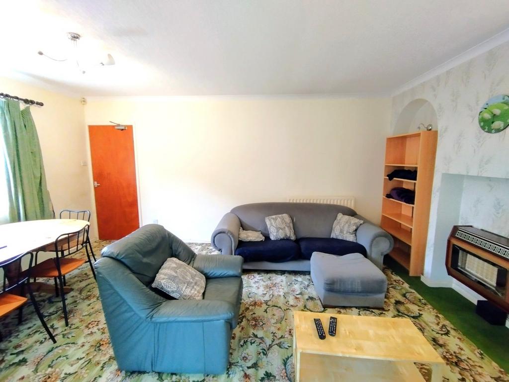 Bright, comfortable living room with a mix of s...