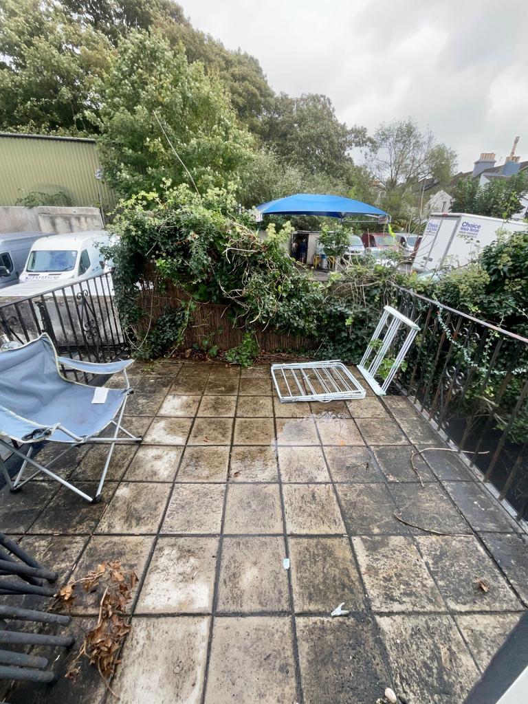 Private paved patio with railings and outdoor s...