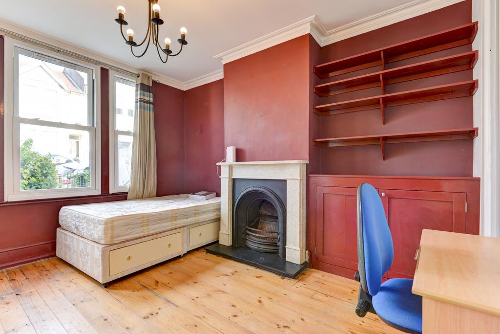 Bright double bedroom with a large sash window,...