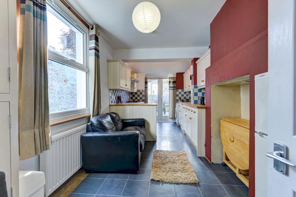 Bright open-plan kitchen with large window, mod...