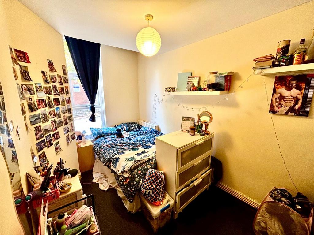 Cozy bedroom featuring a bed with vibrant beddi...