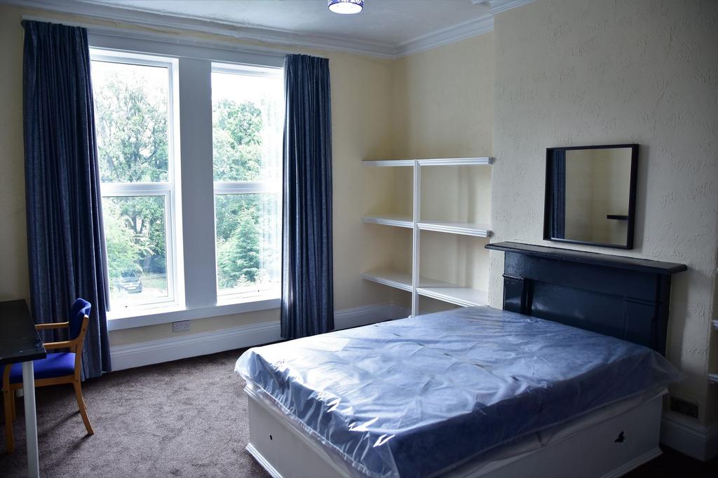 A bright and well-maintained bedroom featuring ...