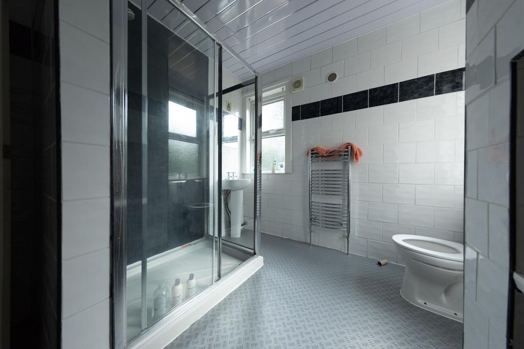 A tidy bathroom featuring a large shower cubicl...