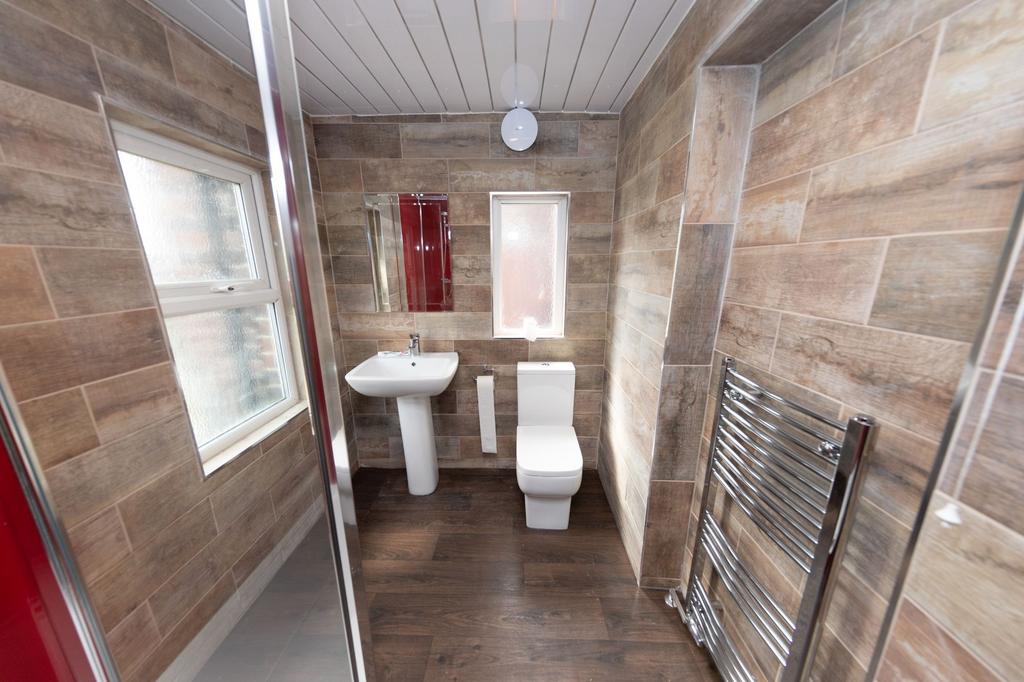 Modern bathroom featuring a white toilet and sm...