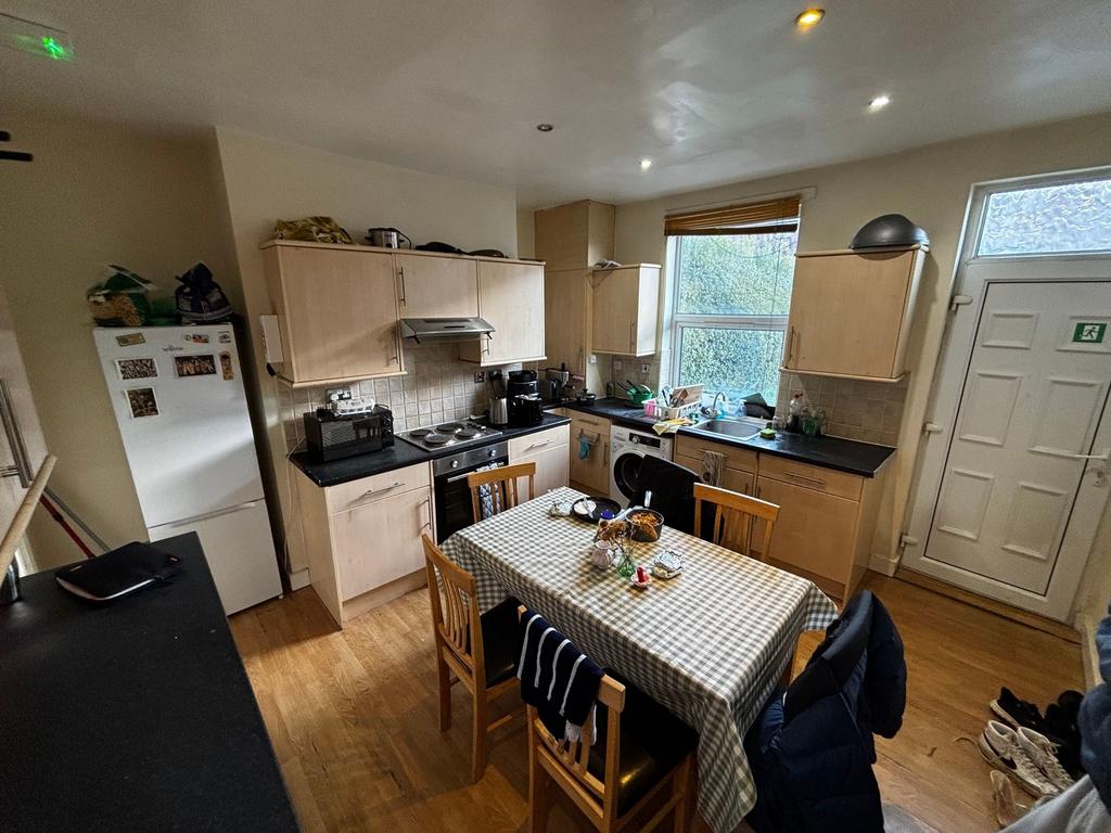 Bright, practical kitchen with a central dining...