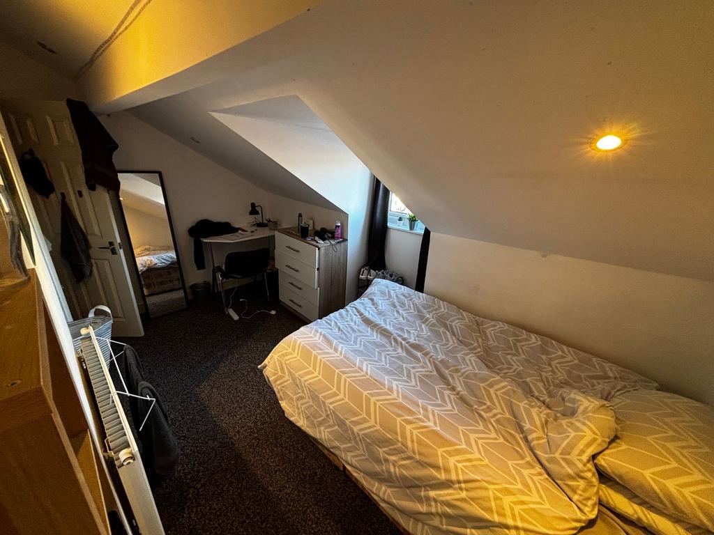 Cozy double bedroom in an attic-style space wit...