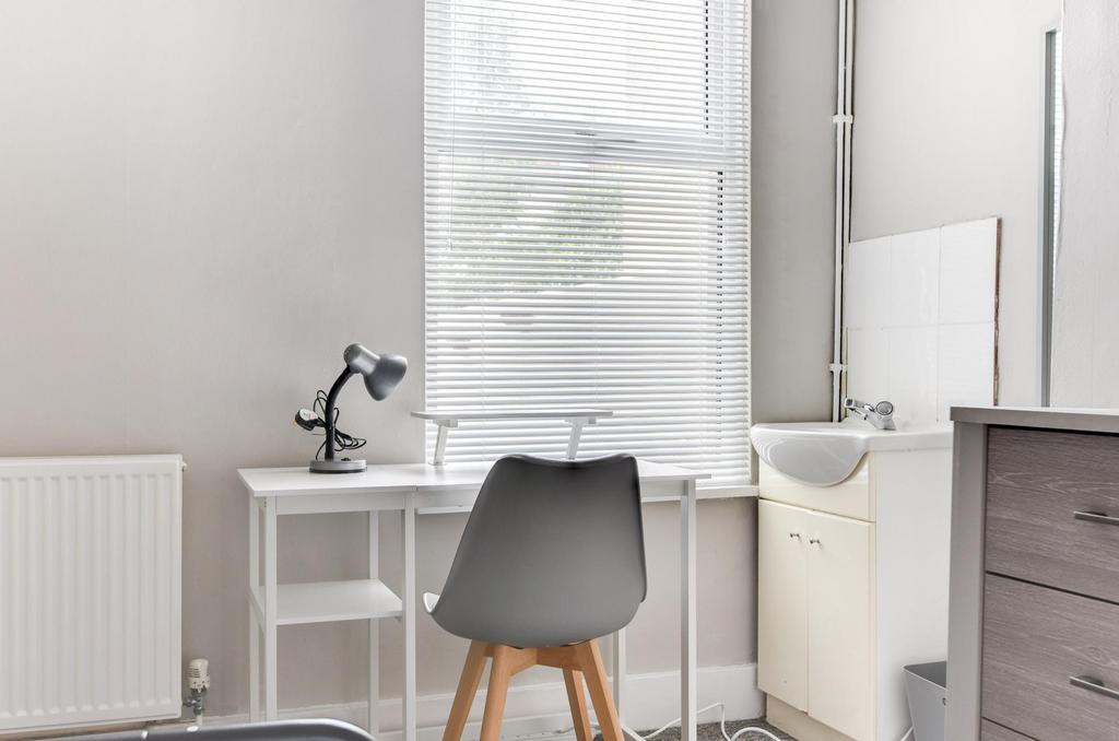 Bright, tidy bedroom corner with a compact desk...