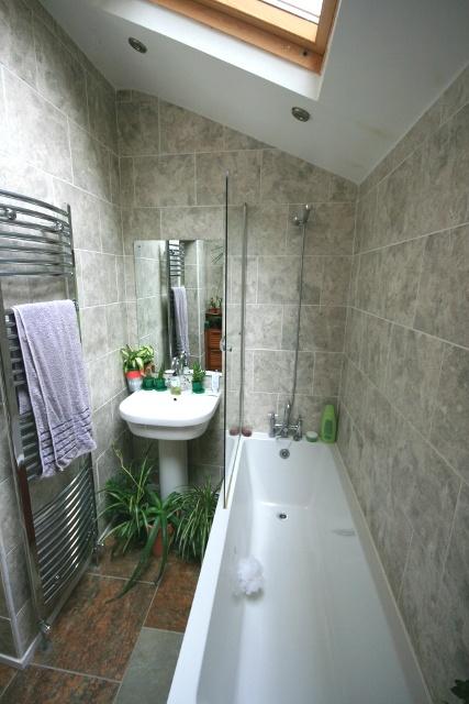 A modern bathroom featuring a spacious bath, a ...