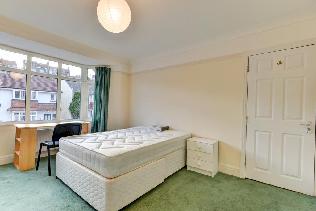 Bright double bedroom with large front-facing w...