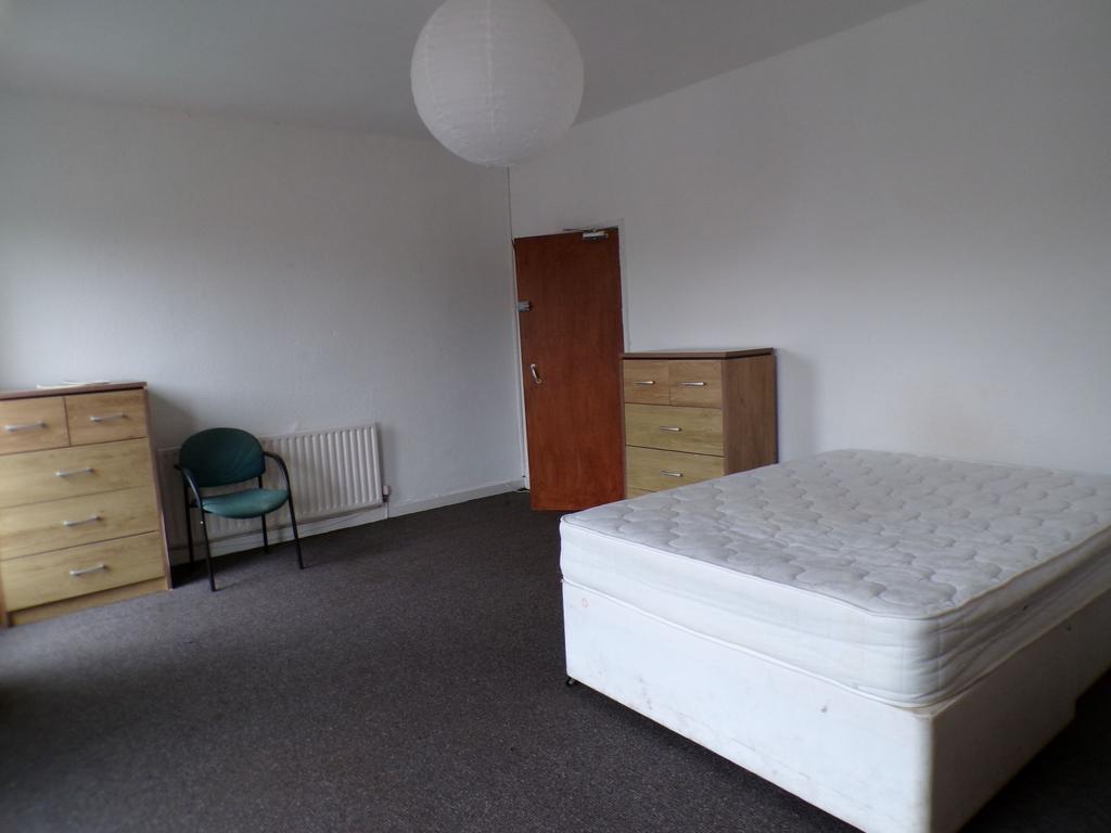 Bright, spacious bedroom with a double bed, two...