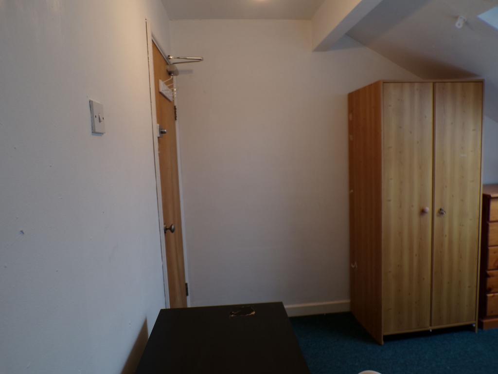 Compact furnished bedroom with a freestanding w...