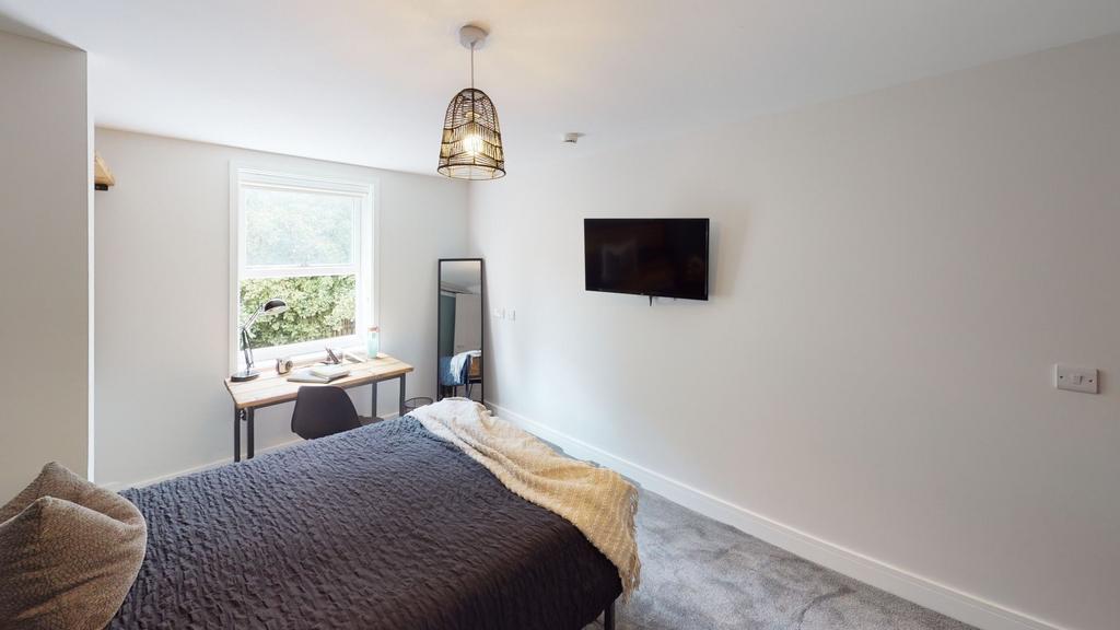 Bright and airy living room featuring a large w...