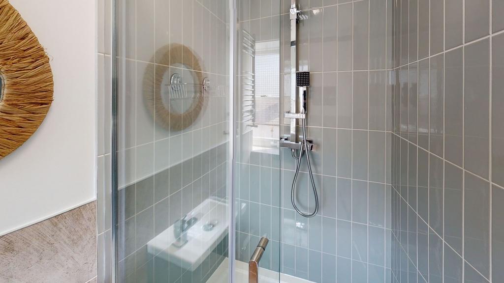 Modern bathroom featuring a walk-in shower with...