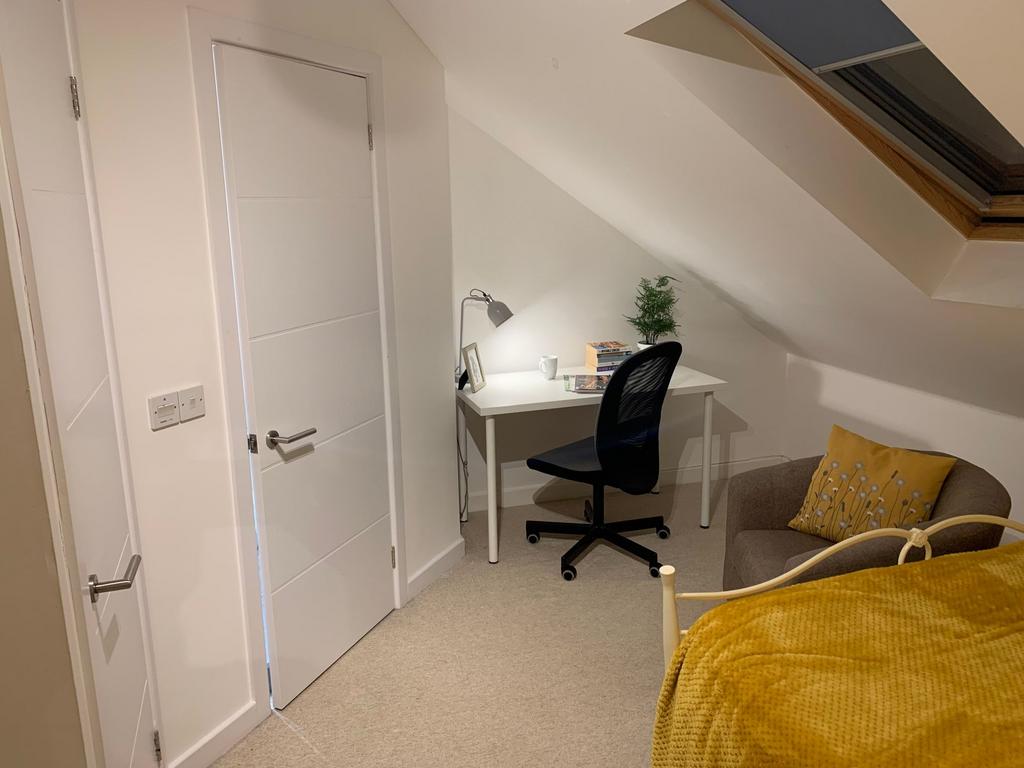 Bright, well-kept upstairs bedroom with a cozy ...