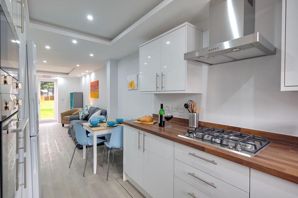 Contemporary open-plan kitchen and dining area ...