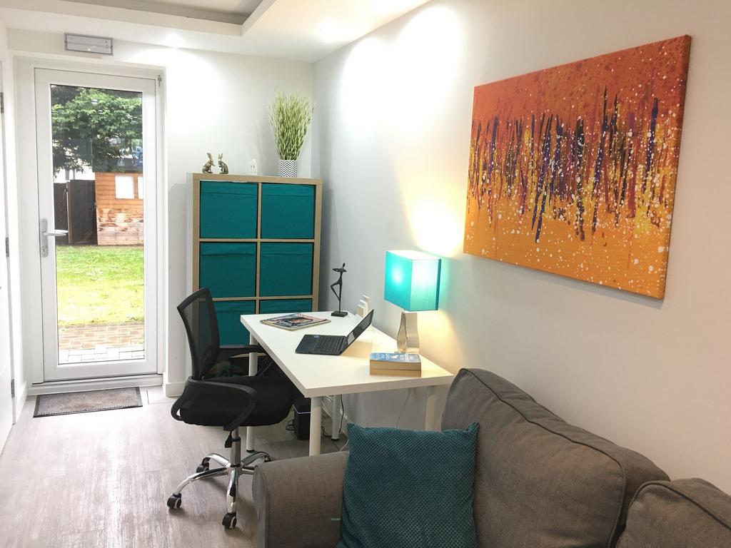 Bright, modern workspace with a white desk, erg...