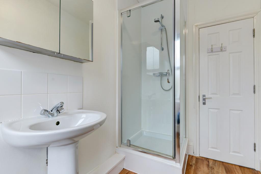 Bright, modern bathroom with a corner shower cu...