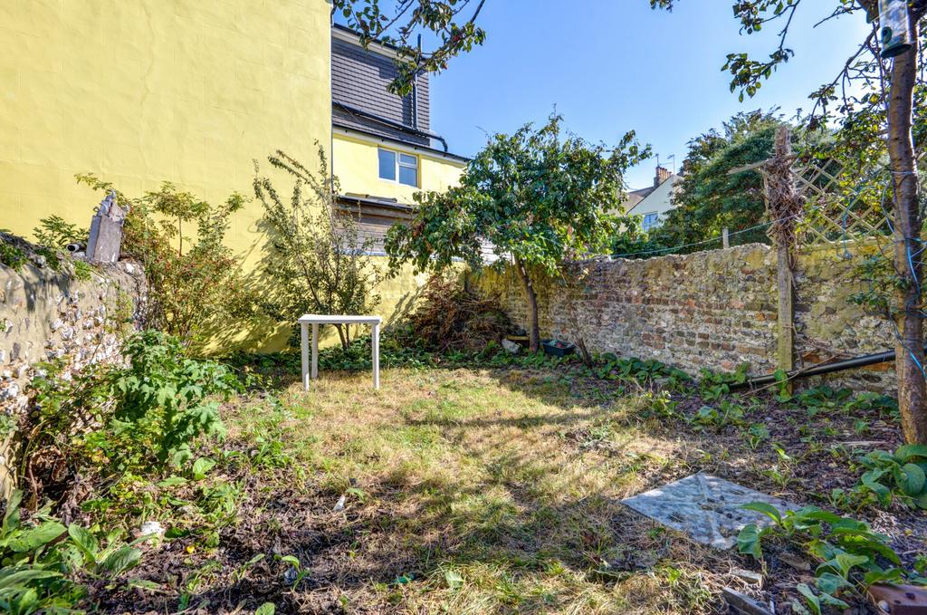 A well-maintained garden area featuring lush gr...