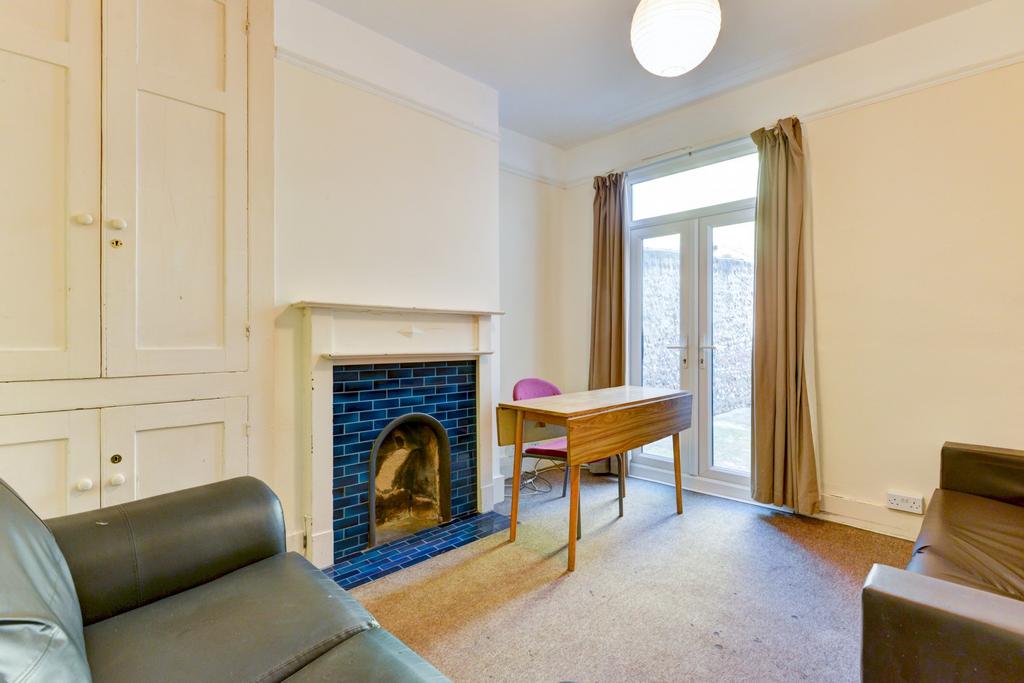 A bright and welcoming living room featuring la...