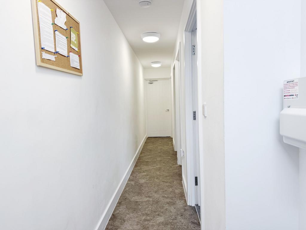 Bright, freshly painted internal hallway with r...
