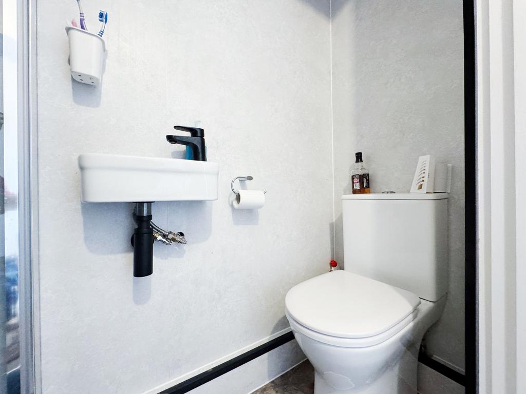 Bright, modern bathroom with a compact wall-mou...