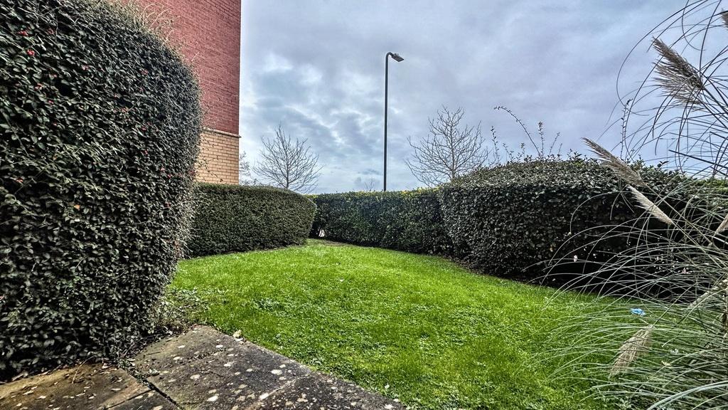 Well-maintained private garden with a neat lawn...