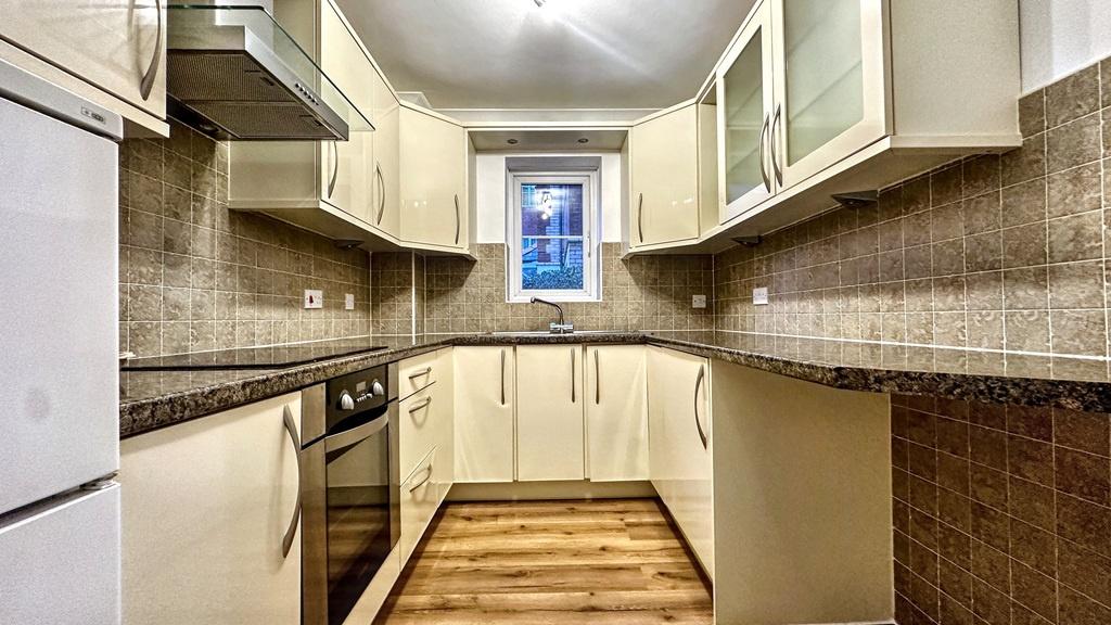 Bright, modern galley kitchen with light cabine...