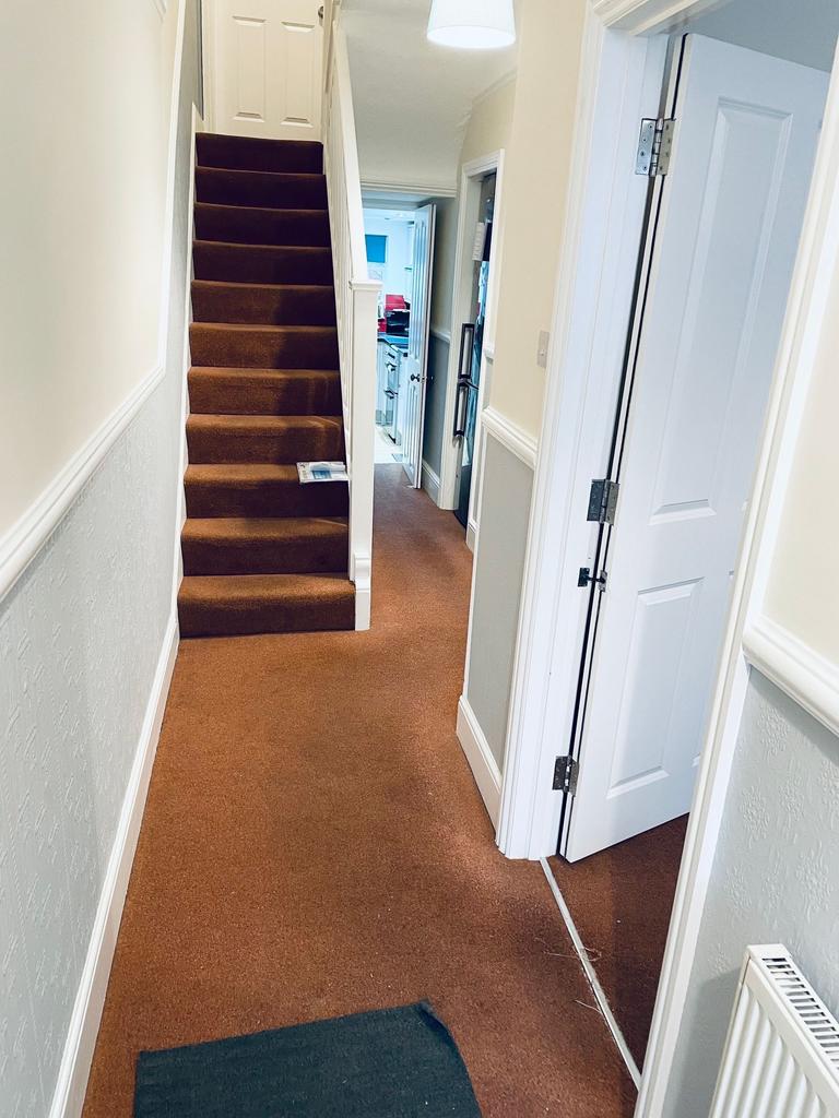 Bright, well-maintained entrance hallway with a...